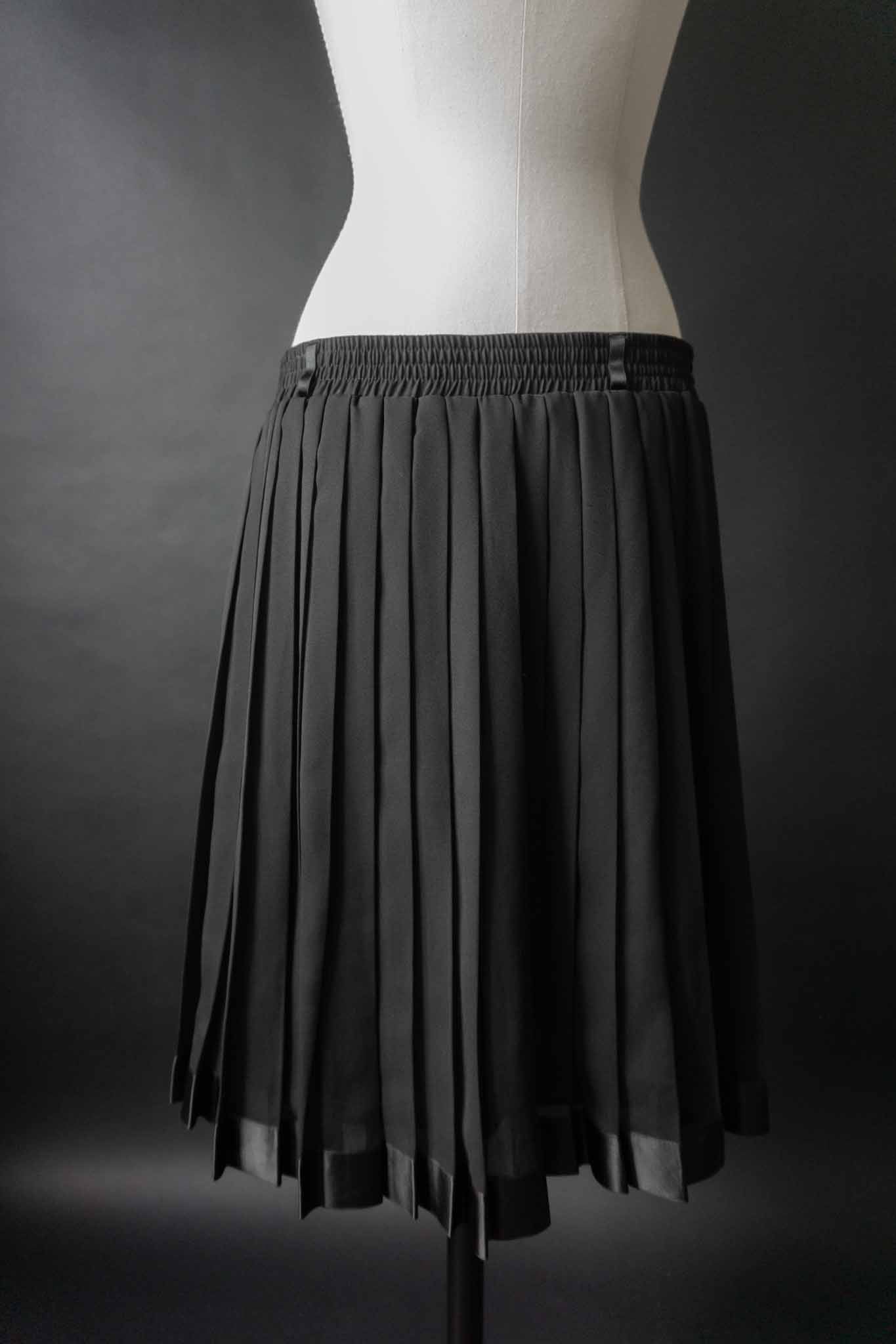 Schwarzer Vintage-Faltenrock mit Satin-Saum